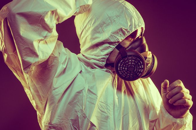 a person wearing a protective medical suit and face mask