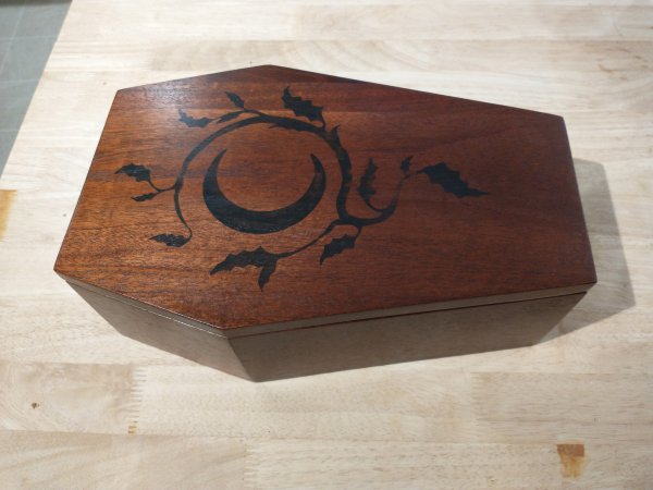 coffin shaped wooden wedding card box on table